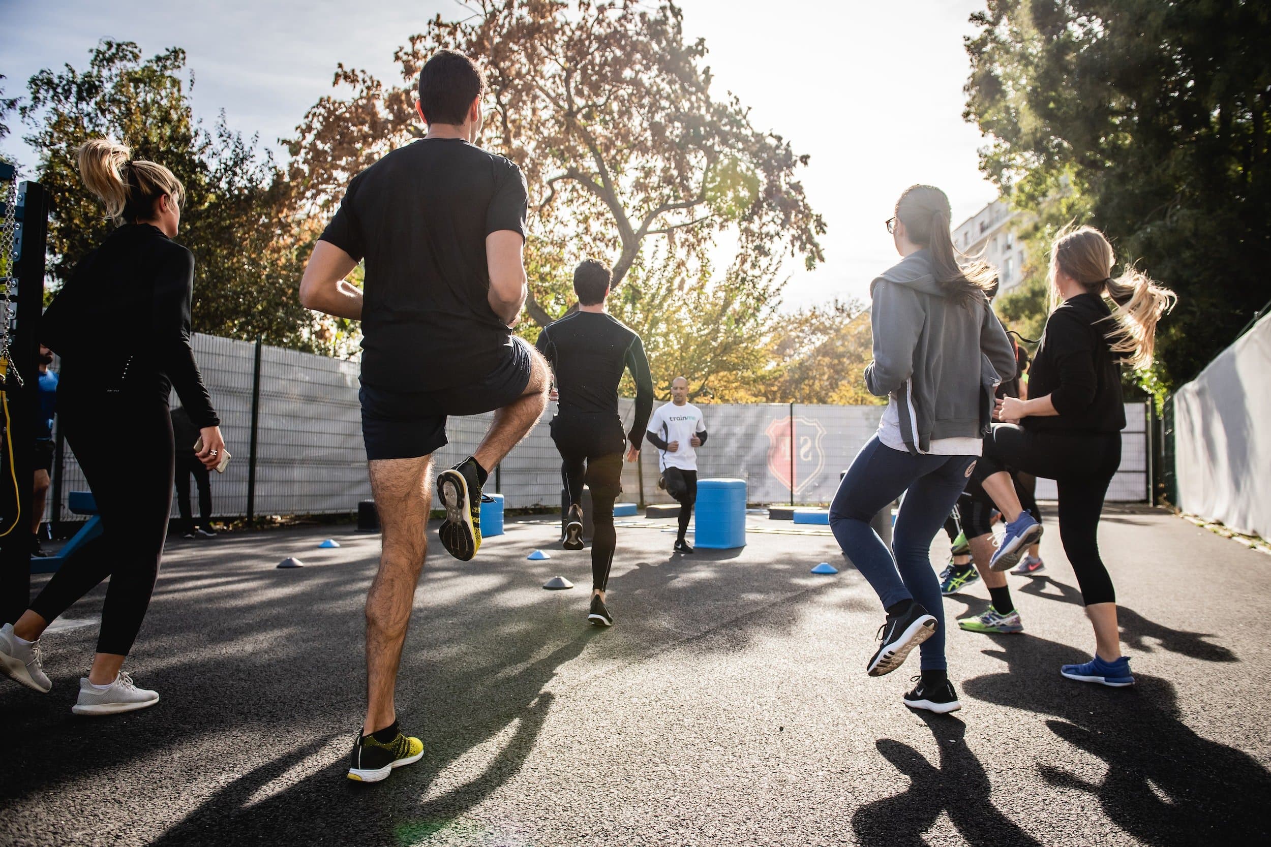 A group of people exercising in a yard.